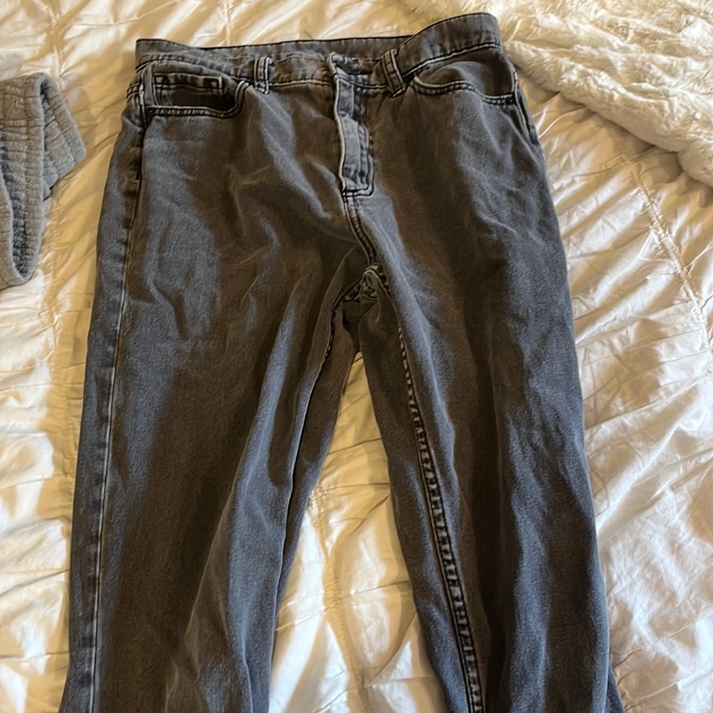 Grayish/black jeans with small tear